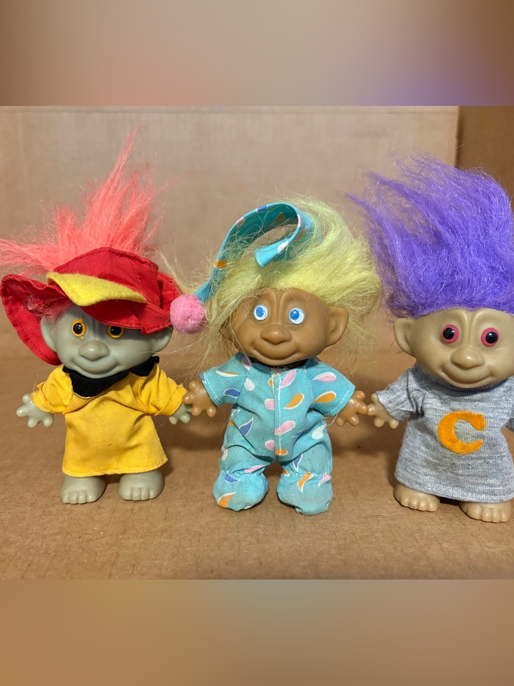 Lot of 3 vintage 4” troll doll one in pajamas, fire chief & over size shirt